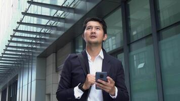 Businessman carrying bag and talking on phone while traveling to work. Concept of using technology in business while traveling. video