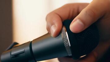 A hand adjusting a microphone on a conference table, preparing for a speech or presentation. video