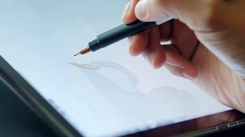 A hand holding a stylus, pointing to a tablet screen during a discussion, highlighting interactive communication. video