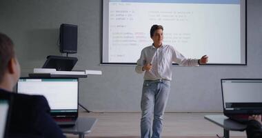 Confident And Joyful Teen Boy Presenting His Computer Software In Classroom Or Conference Of Coding video