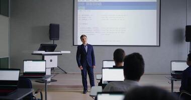 Genius Teen Boy Presenting His Project In Programming Classroom, Classmates Looking At Display video