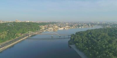 Wide river in city with bridge. Cityscape architecture bridge, river and skyline, urban landmark, aerial sky, downtown panorama europe view, panoramic wide district video