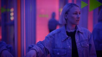 A woman in neon lights at a modern art installation, in an aesthetic and ambient atmosphere video