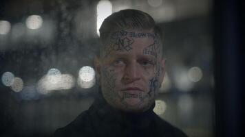 Man with facial tattoos in urban setting represents alternative and artistic attitude video