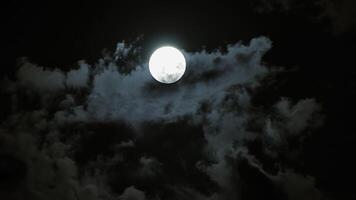 Night sky is peaceful with full moon, drifting clouds, and an ethereal atmosphere video