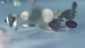 Coins falling on grayscale background, symbolizing finance, economy, and wealth video