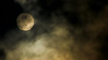 Serene Full Moon Surrounded by Clouds in the Night Sky is enchanting and atmospheric video