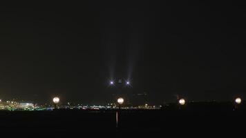 An aircraft is making a nighttime runway landing with its bright headlights beaming video