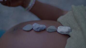 Experience the tranquility of the beach as pebbles softly touch your skin under the setting sun video
