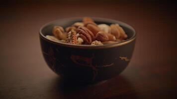 Various nuts in a bowl under cozy lighting, creating an elegant and appetizing display video