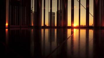 Enjoy the view of a modern urban sunrise through the glass windows of a highrise building video