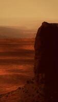 A rock formation in the middle of a desert video