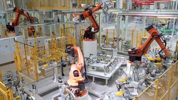 Russia, Moscow - May 7, 2022. Automated plant with robotics and workers. Scene. Lot of robotic machines create car parts in modern factory. Modern robotic equipment at factory with workers video