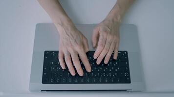 Hands typing on keyboard. Action. Top view of hands typing on laptop keyboard. Person is typing on new laptop in minimalist style video