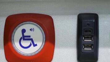 Close-up button for disabled people. Media. Help button for people with disabilities. Button to help disabled people in public transport video
