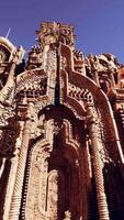 A towering building adorned with ornate statues on its walls video