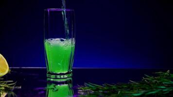 Blue background with a drink . Stock clip . A bright background on which tarragon is poured and a lemon with a fir branch lies next to it. video