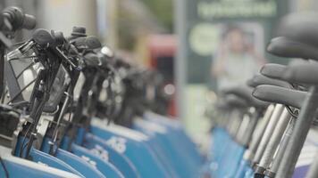 Rows of bicycles for rent. Action. A lot of identical bikes are in row. Street bikes for rent in modern city. Small public transport system for rent video