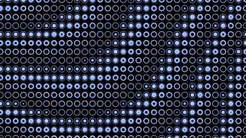 Abstract rows of small same size rings on a dark background. Design. Spinning slowly wavy pattern of blue small circles. video