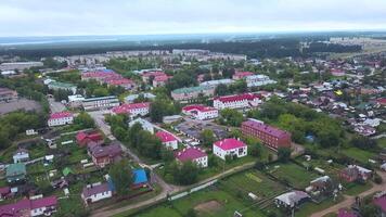 Russia.The view from the drone.Clip. A big city from a height where you can see summer houses and green trees around and a big bridge over the river that spreads and you can see the white fog over the video