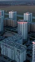 Aerial view of a beautiful city with high rise buildings and greenery. Stock footage. Concept of urbanization, houses on cloudy sky background. video