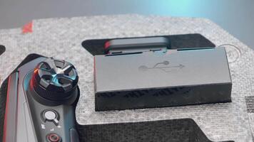 CHINA, BEIJING - MARCH 21, 2022. Parts of the stabilizer lie on a gray table. ACTION. The stabilizer is divided into parts for advertising. The black parts of the stabilizer lies on a gray background video