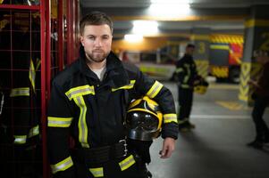 A firefighter puts on a fire uniform at the fire department photo