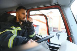 Firefighter drives a emergency vehicle with communication interior view photo
