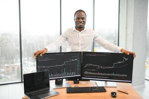 Stock Market Day Trader Working on Computer with Multi-Monitor Workstation with Real-Time Investmentment Charts photo