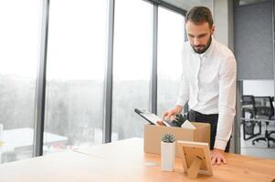 Man by dismissal. Guy lost job. Fired manager in company. Dismissal box in hands of employee. photo