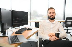 Crypto trader sits at his workplace in front of a monitor with charts. photo
