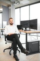 Financial Analysts and Day Traders Working on a Computers with Multi-Monitor Workstations with Real-Time Stocks, Commodities and Exchange Market Charts photo