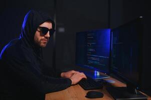 Hacker is hacking into the computer network. Computer criminal photo