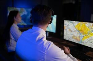 Diverse call center operators team use computers consulting clients in office photo
