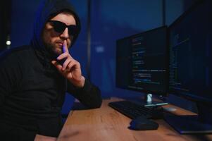Wanted hackers coding virus ransomware using laptops and computers. Cyber attack, system breaking and malware concept photo