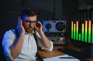 A male spy listens and records conversations on a reel-to-reel tape recorder photo