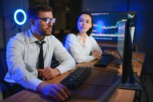Business team investment working with computer, planning and analyzing graph stock market trading with stock chart data photo