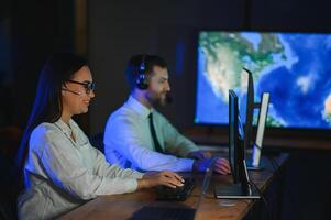 Diverse call center operators team use computers consulting clients in office photo