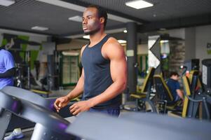 Man running on treadmill in gym photo