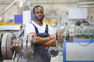 An African-American male worker in a plastic window frame factory photo