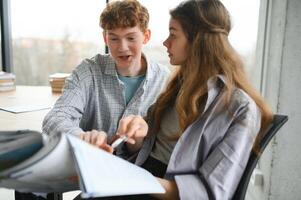 Group of college students doing homework photo