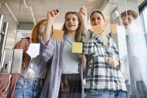 students discuss university assignments together photo