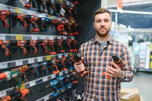 Man shopping for drill in hardware store photo