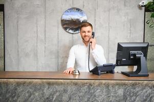 Portrait of receptionist at desk in lobby photo