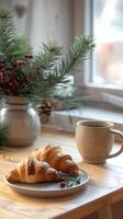 Fragrant black coffee in a beautiful ceramic cup, crispy fresh croissants on a wooden table decorated with spruce branches and cranberries photo