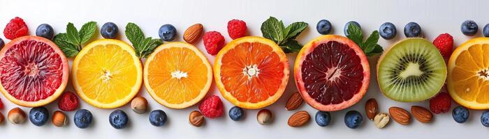 A minimalist composition of various fresh fruit slices and nuts, neatly organized on a pristine white background, panoramic space above for copy. photo