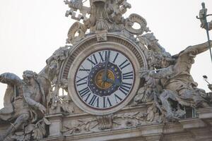 Close up view of the clock on top of the Vatican city. photo