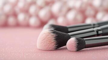 Makeup Brushes on Pink Background With Decorative Pearls photo