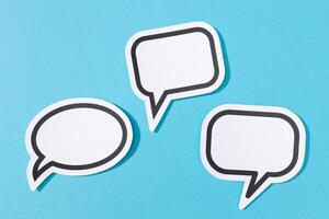 Group of three Blank Speech Bubble isolated on blue background. Mock up template photo
