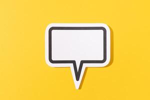 Blank Speech Bubble isolated on yellow background. Mock up template photo